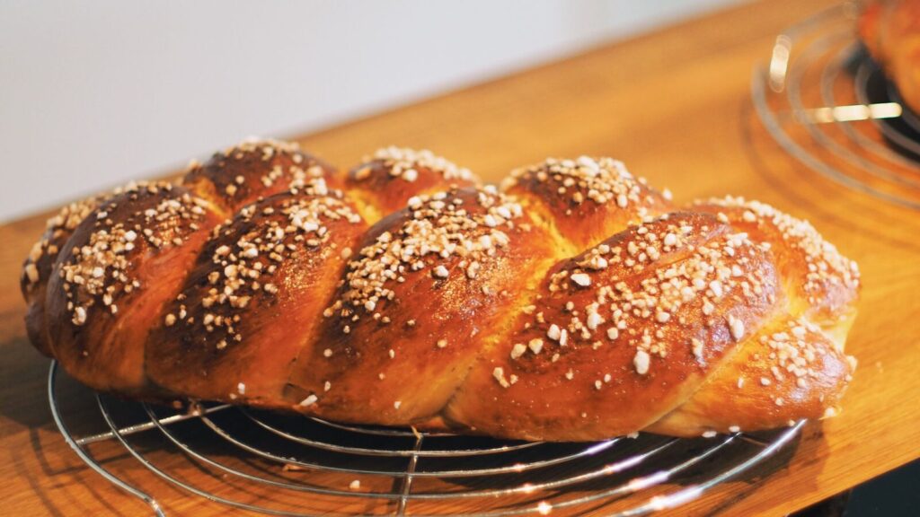 Une brioche dorée sortie du four et posée sur un torchon