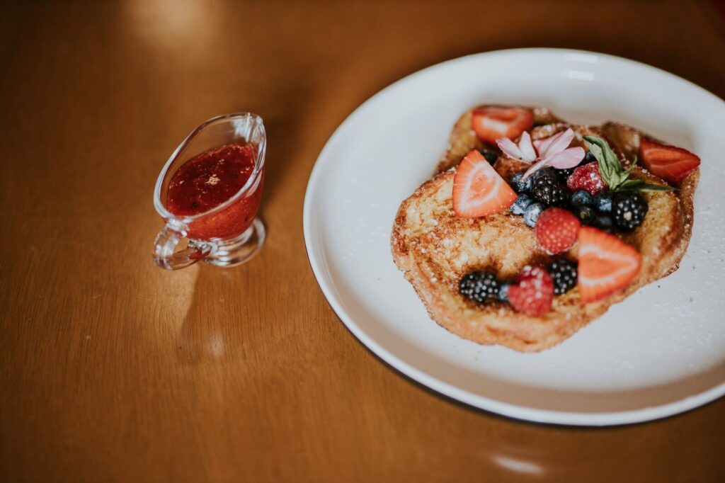 Du pain perdu servi avec un filet de sirop et du sucre glace